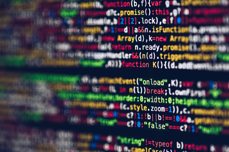 A close-up photograph of a computer screen displaying colorful lines of programming code, including syntax highlighting with words like 'function', 'var', 'console', and 'return' in various colors suc